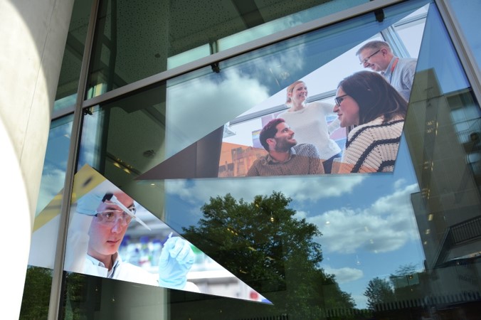 A wall with students as part of the design from The Francis Crick Institute